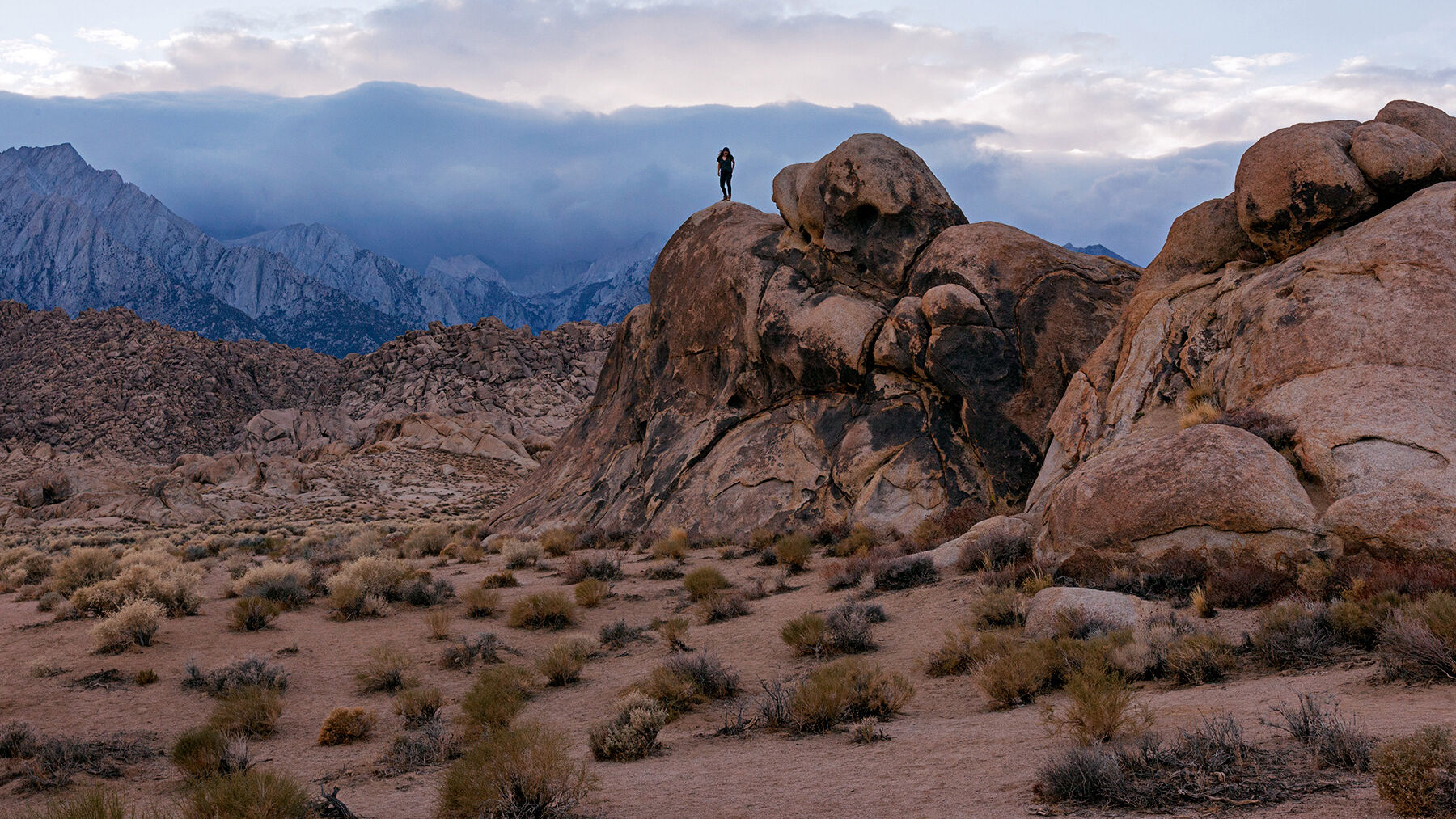 Lydia scrambling around the rock formations at Alabama Hills, California