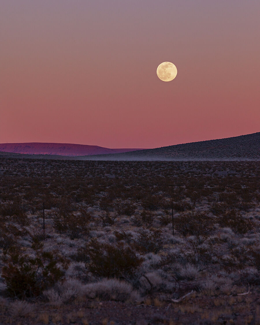 A full moon over a colorful sunset in Nevada