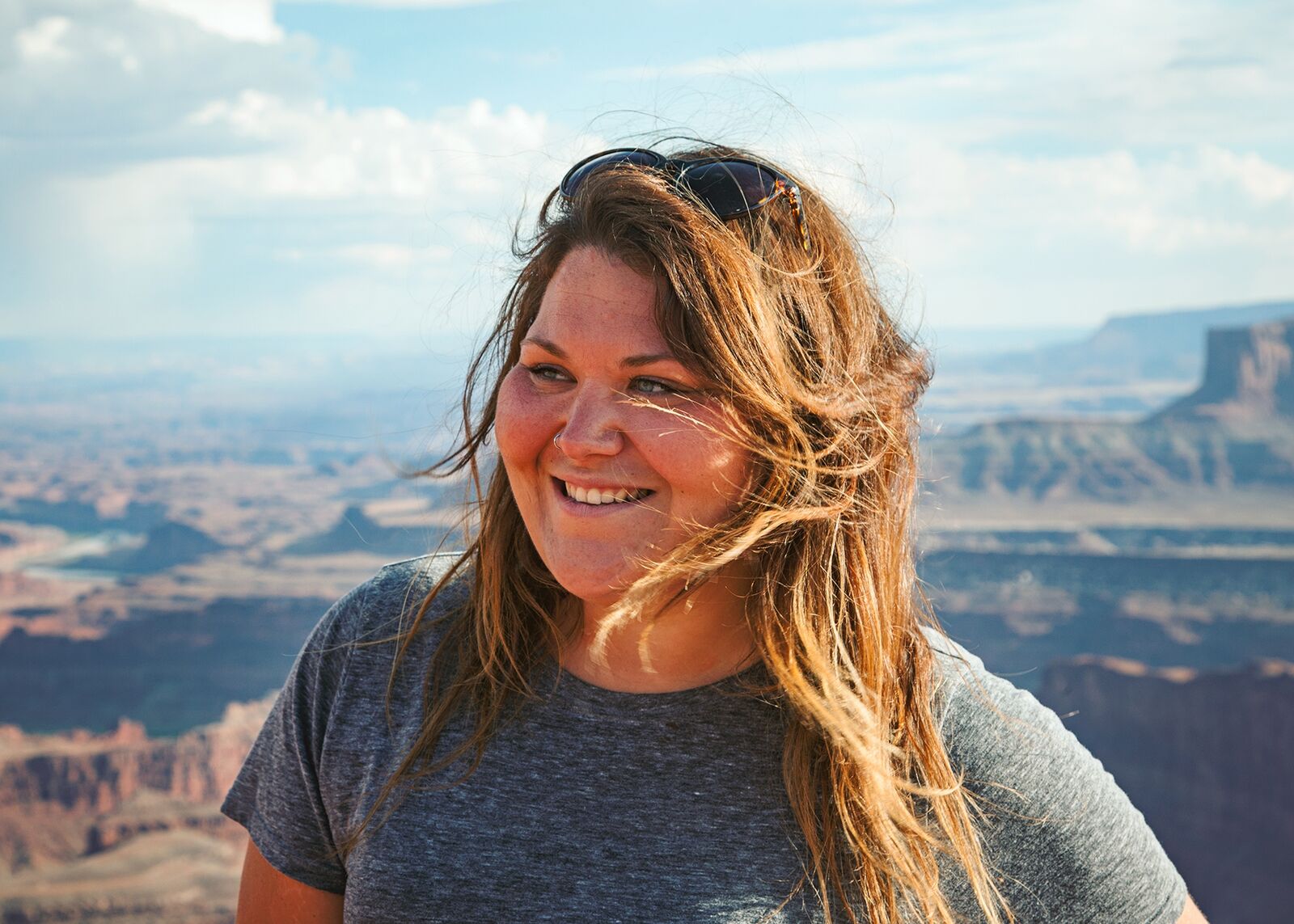 Chelsey smiling at the rim of Dead Horse Point in Moab, Utah