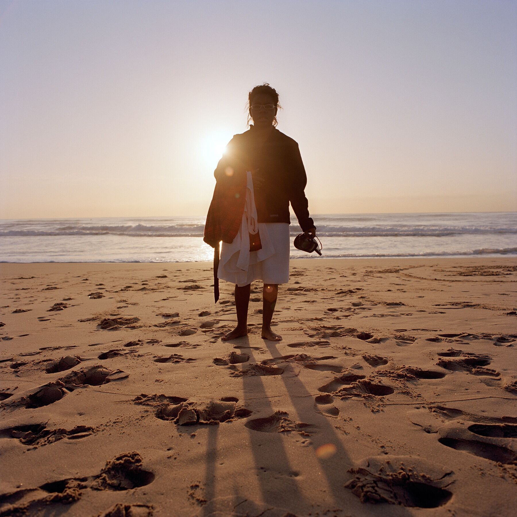 Briana on the beach backlit by an early sun over the Indian Ocean in Durban, South Africa