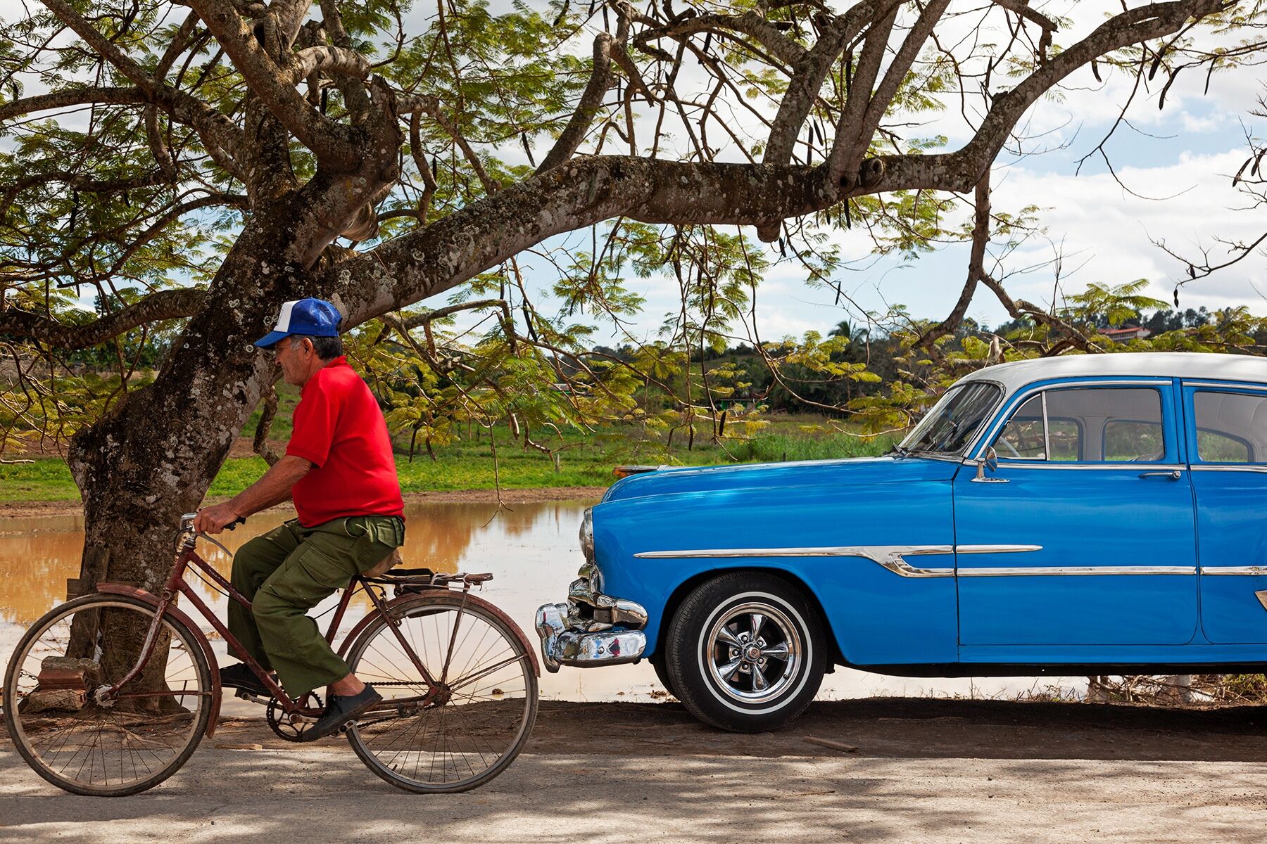 Man riding a bicycle through Viñales, Cuba