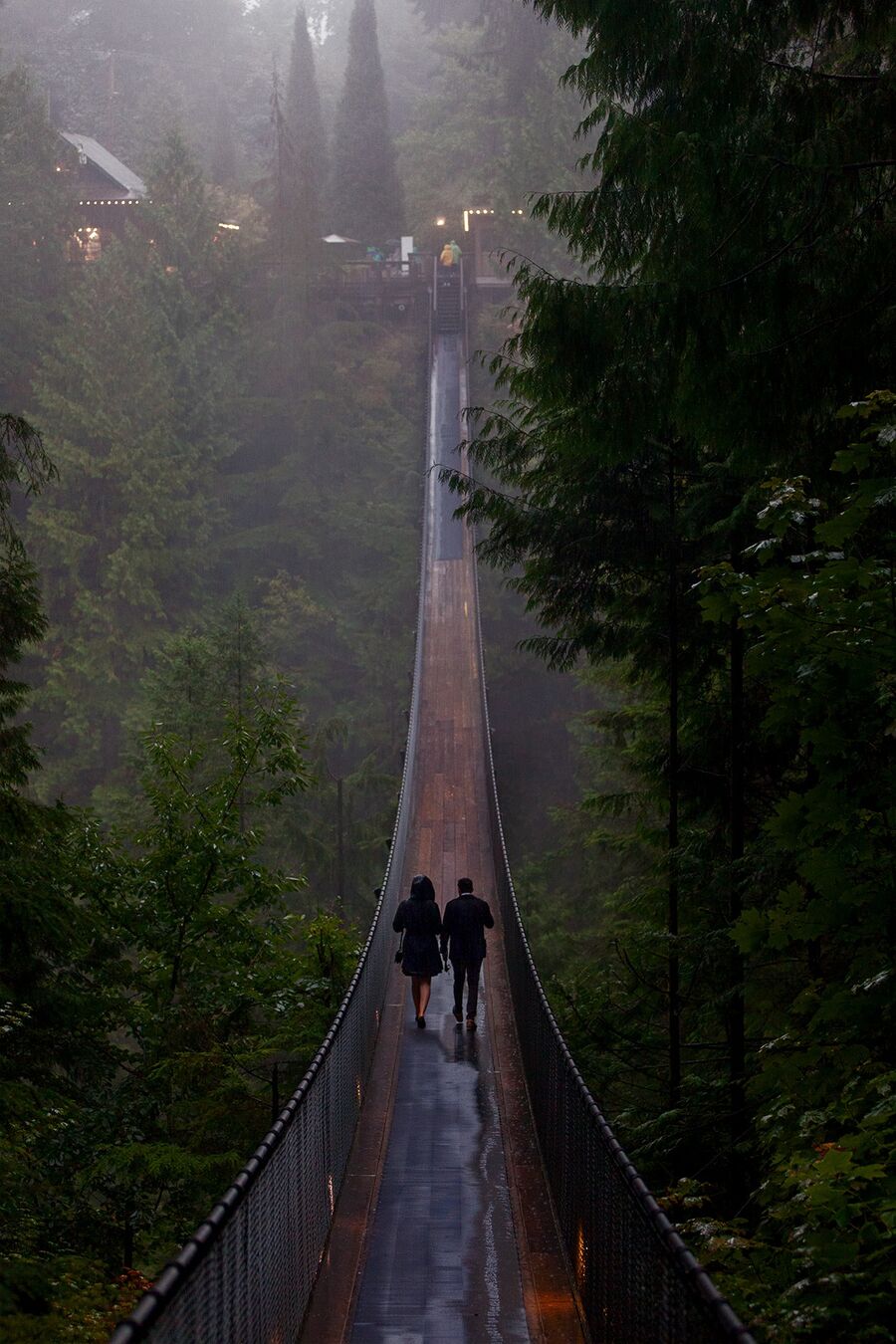 Couple crossing a suspension bridge in North Vancouver, British Columbia, Canada