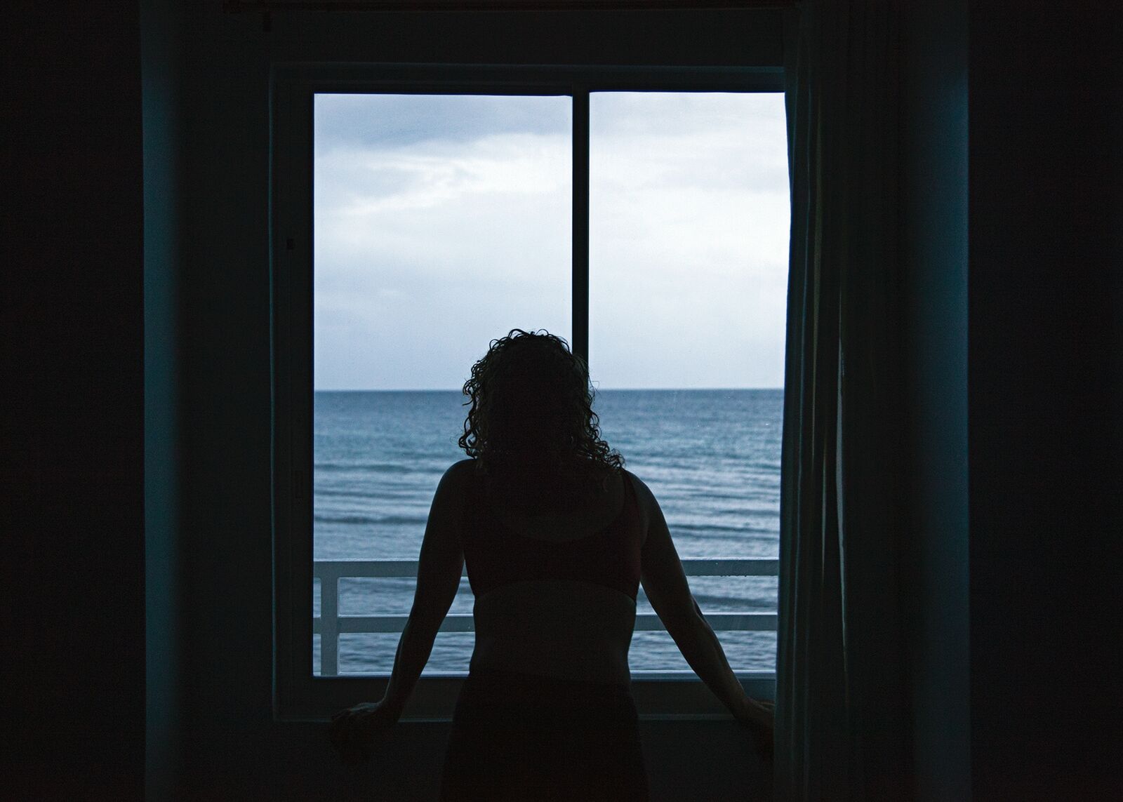 Lydia looking out of the hotel window in Oslob, Philippines