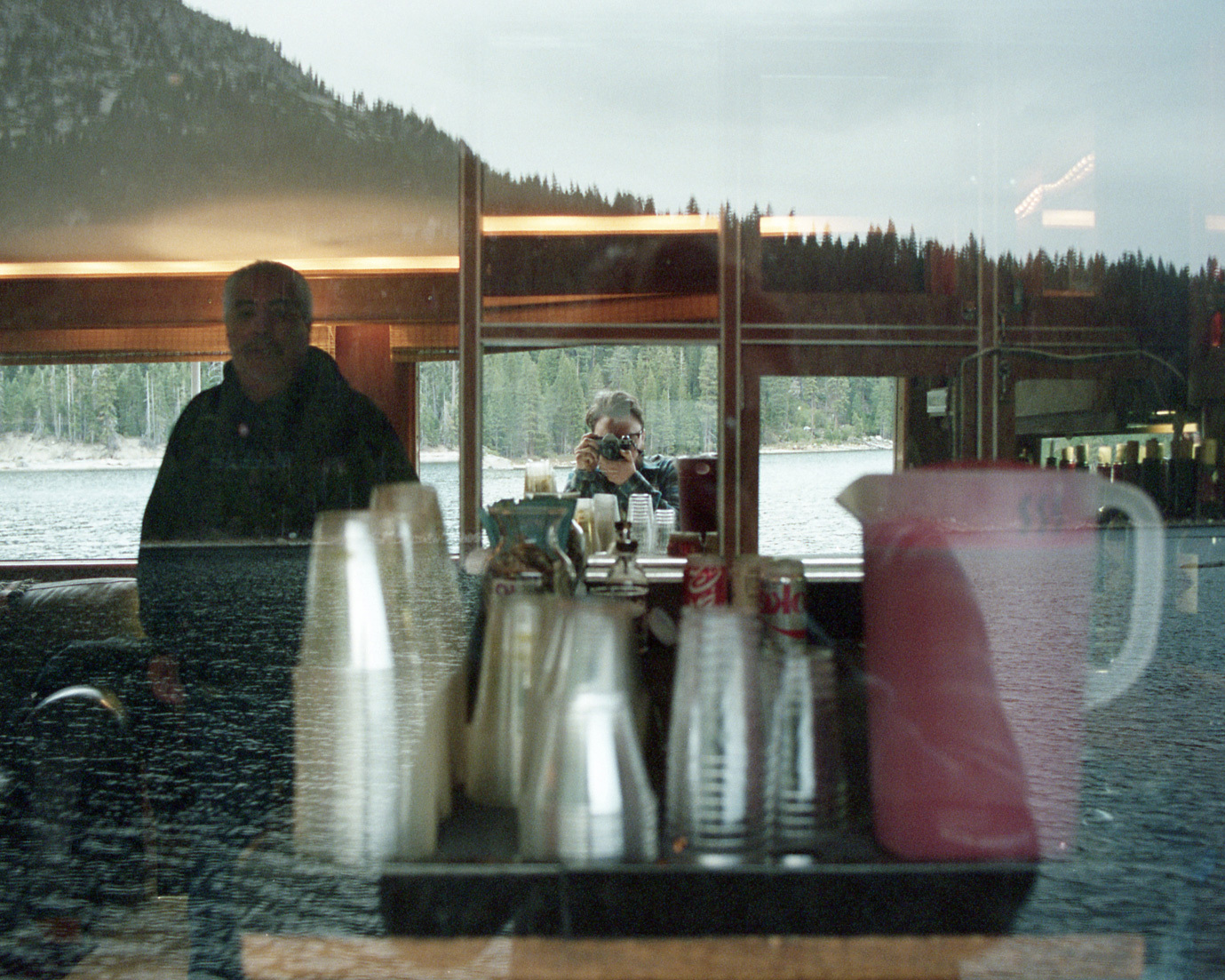 Matt taking a picture looking into a boat on Lake Tahoe with his reflection in a mirror
